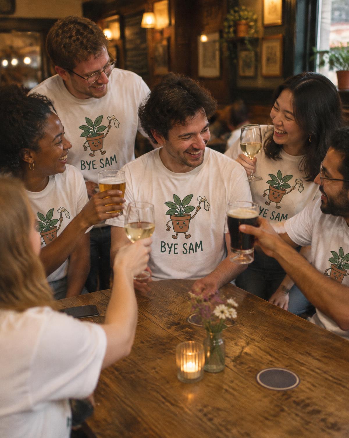 Friends in white Bye Sam tees with a waving plant print clink glasses around a pub table.