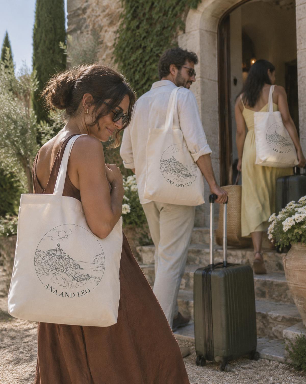 Guests arriving with suitcases at a stone villa, each carrying a natural Ana And Leo welcome tote.