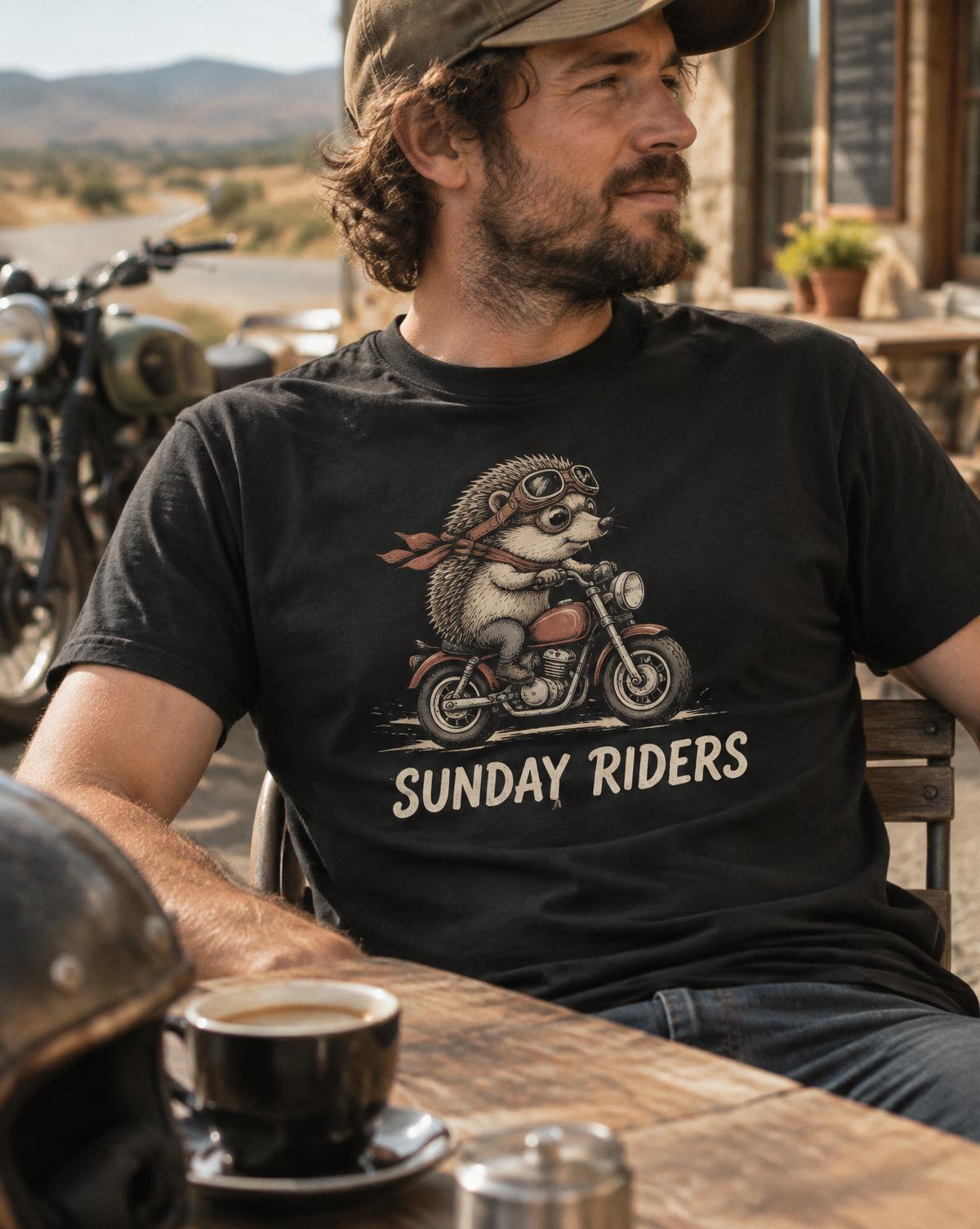 Bearded rider in a black Sunday Riders tee with a hedgehog in goggles on a motorbike, coffee at a cafe.