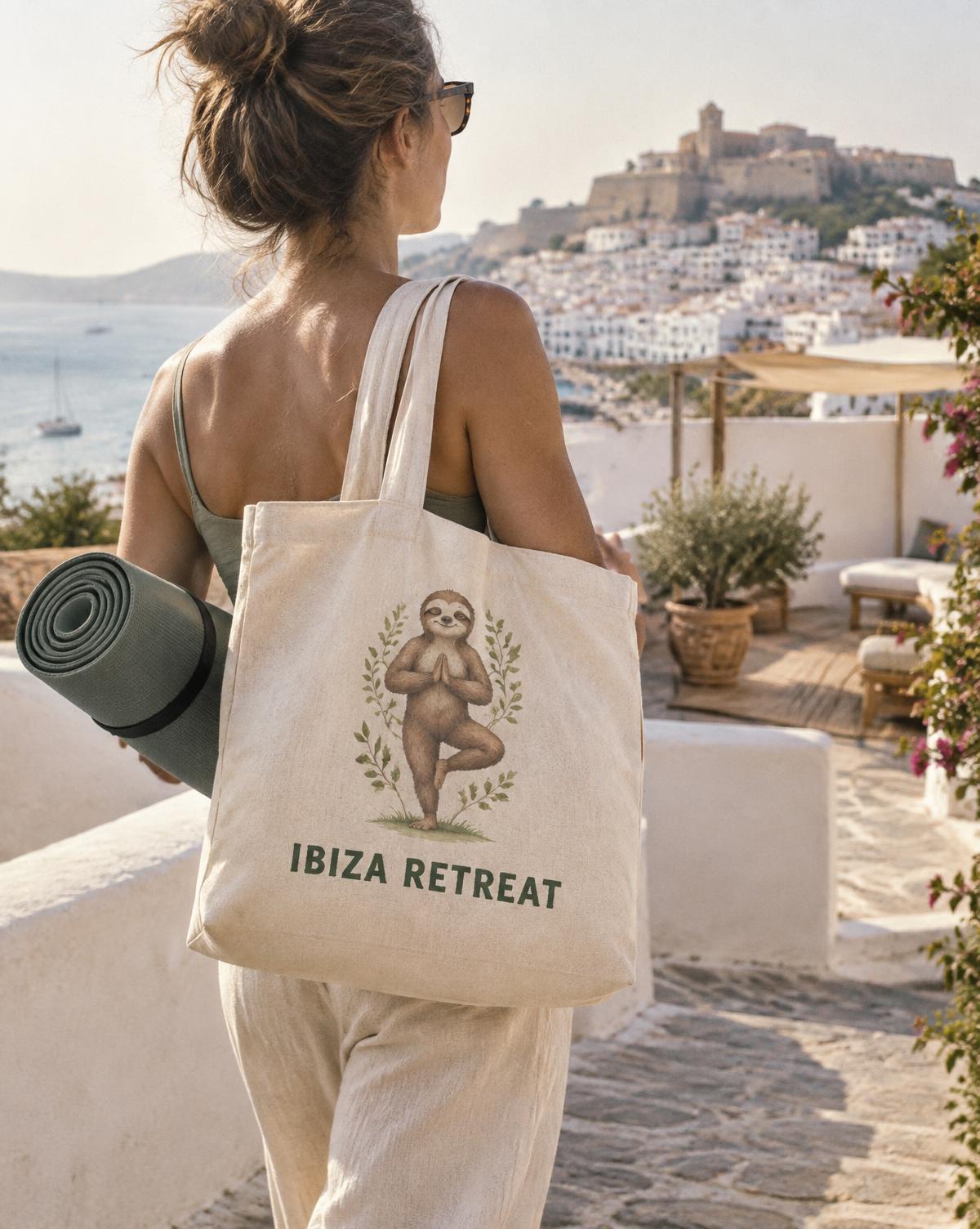 Woman carrying a natural Ibiza Retreat tote with a sloth print and a yoga mat above the old town.