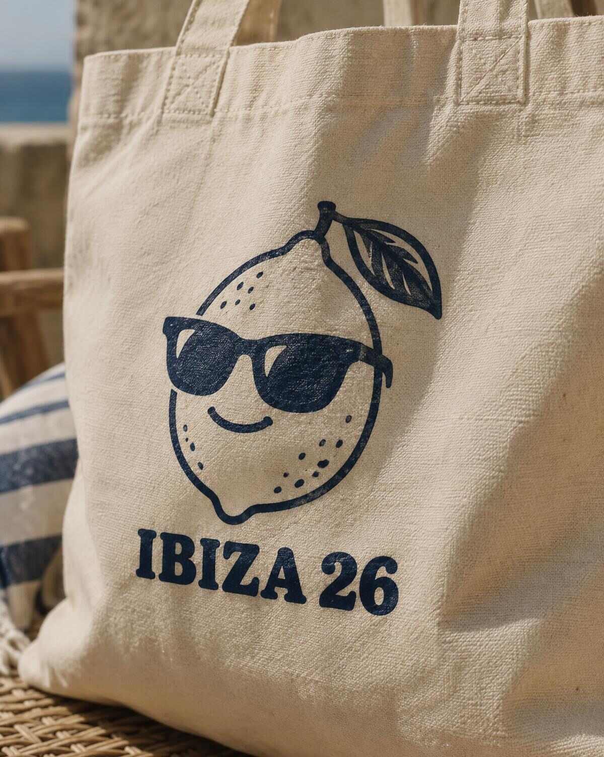 Close-up of a navy lemon in sunglasses and Ibiza 26 print on canvas weave